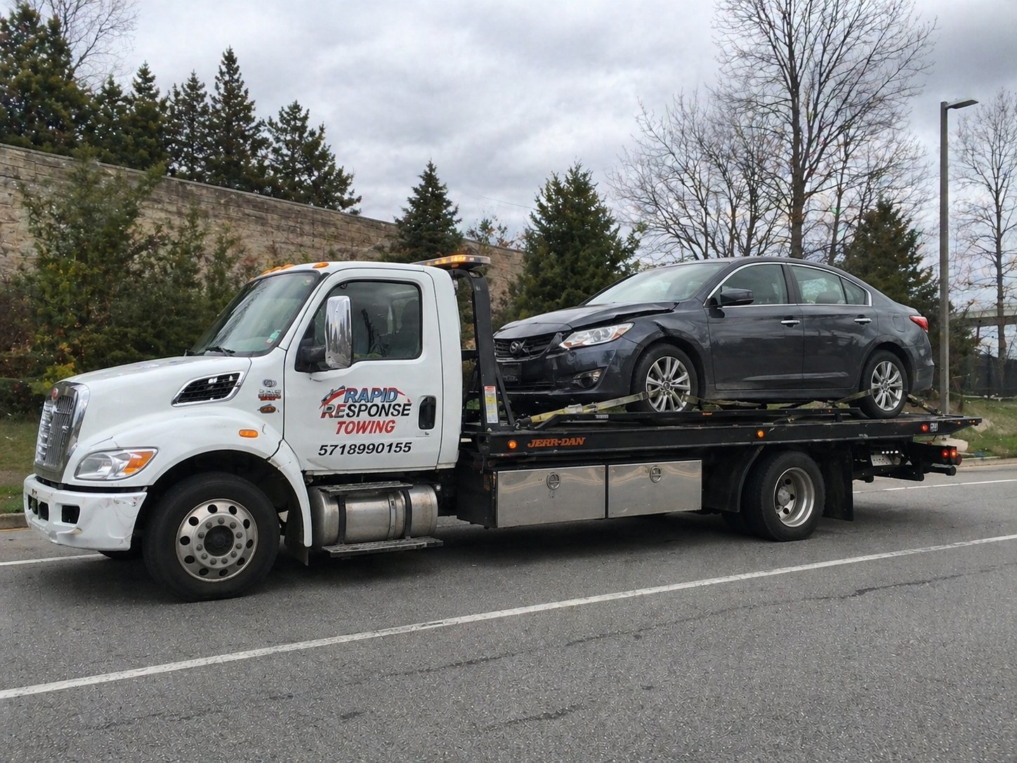 Rapid Response Towing white flatbed truck
